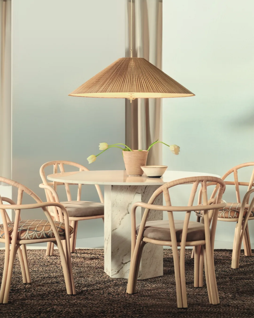 Gubi 1972 Pendant above a marble round dining table surrounded with Bistra dining chairs. 