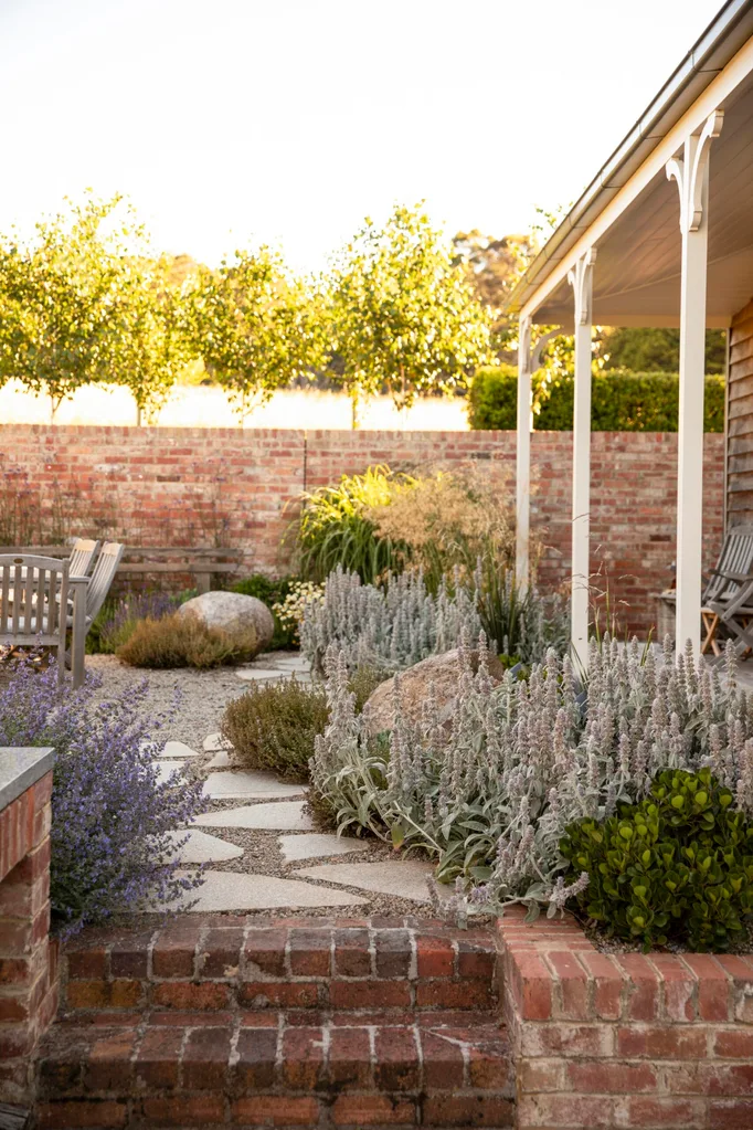 A raised garden bed with lavender and an outdoor dining setting