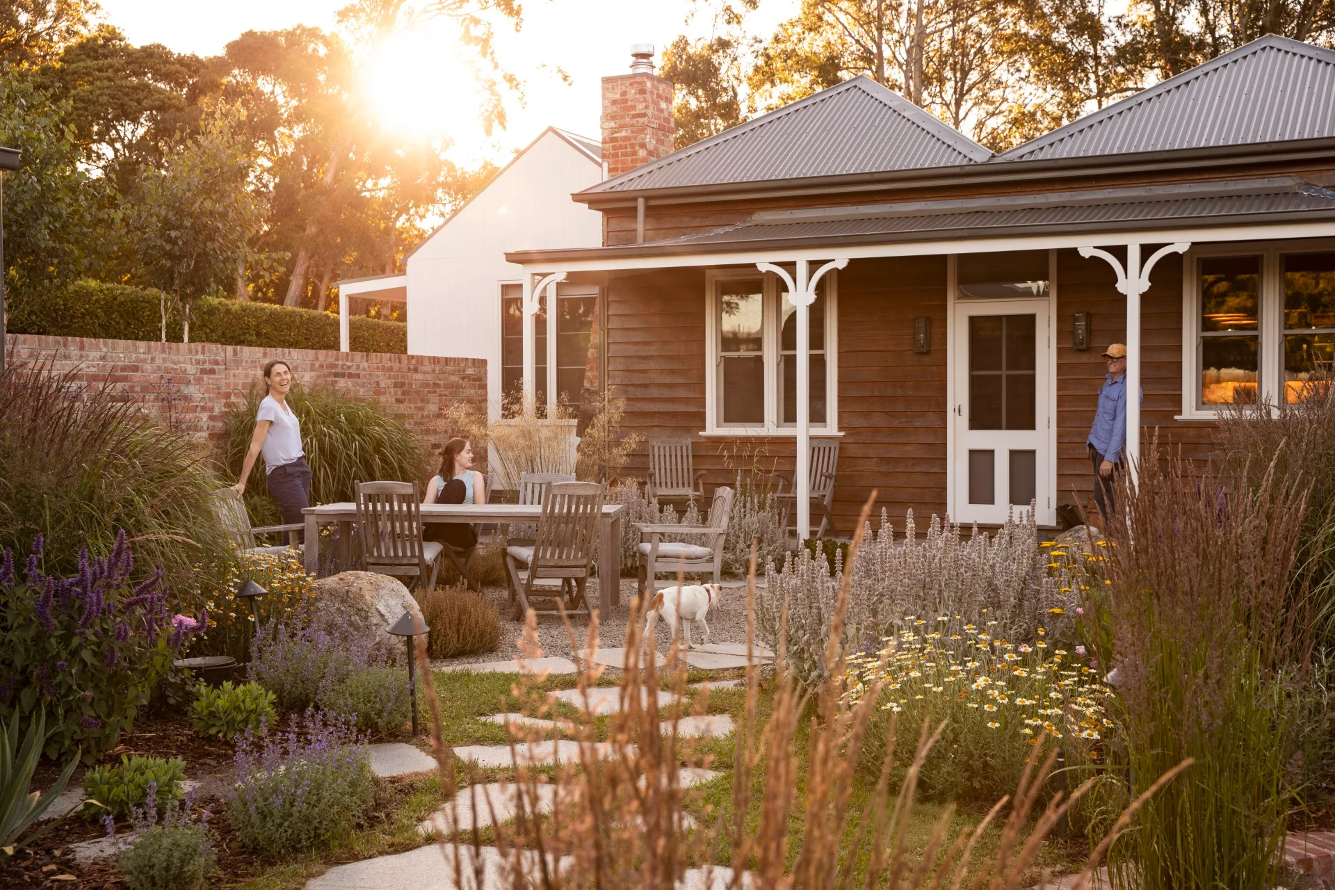 Homeowners Pip and Mal with their daughter Felicity in their layered and colourful garden