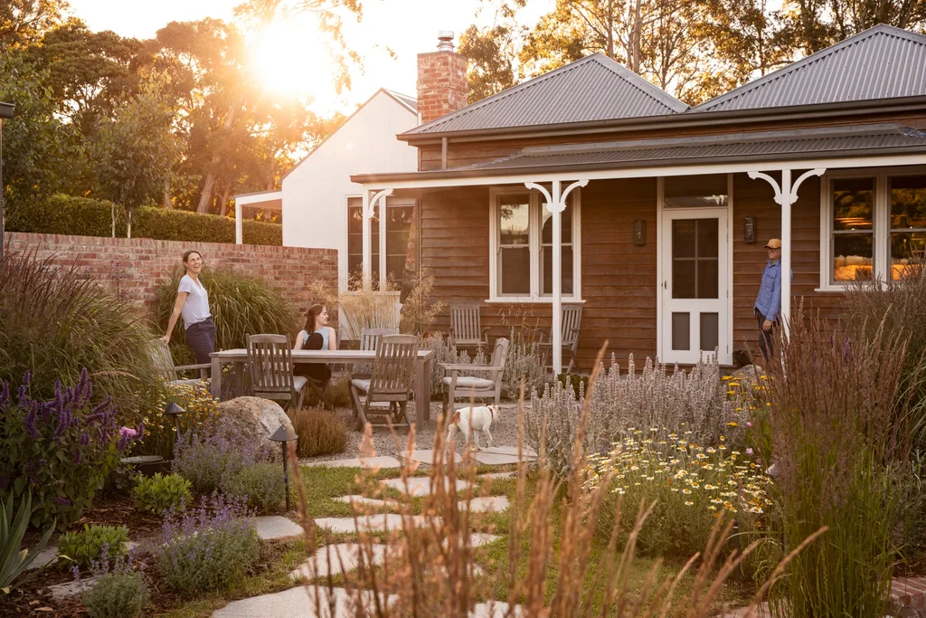 Homeowners Pip and Mal with their daughter Felicity in their layered and colourful garden