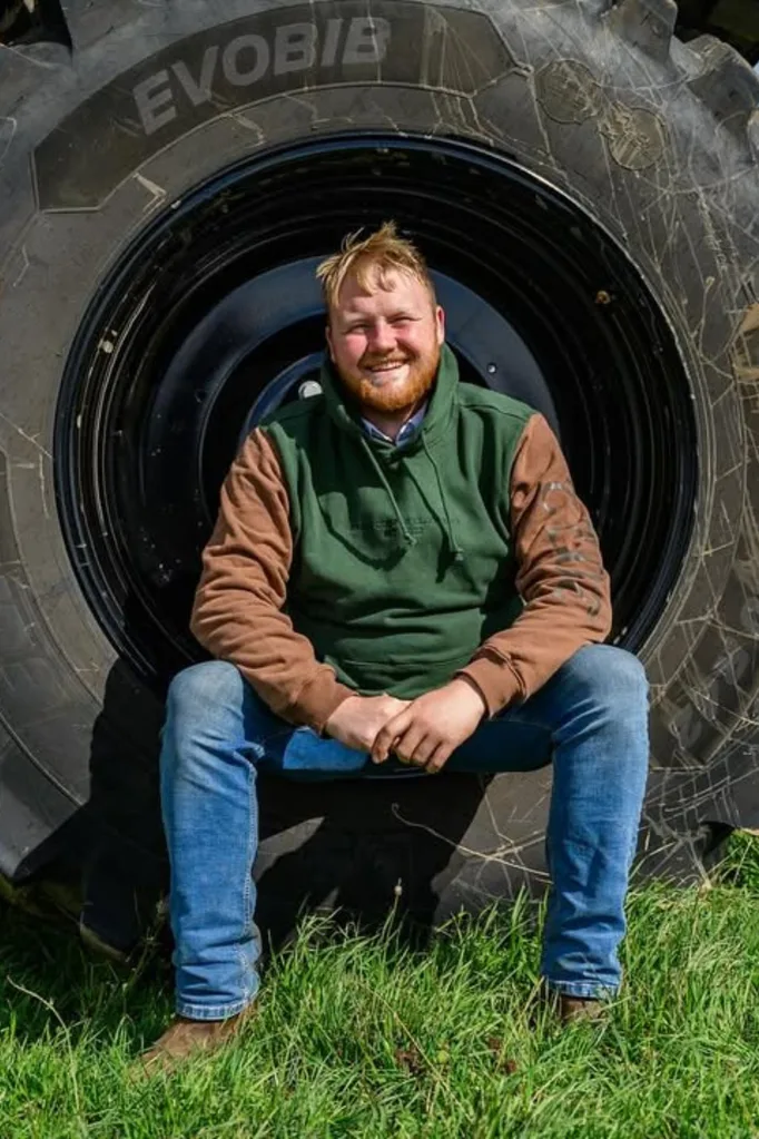 Kaleb Cooper sitting in a tractor tyre