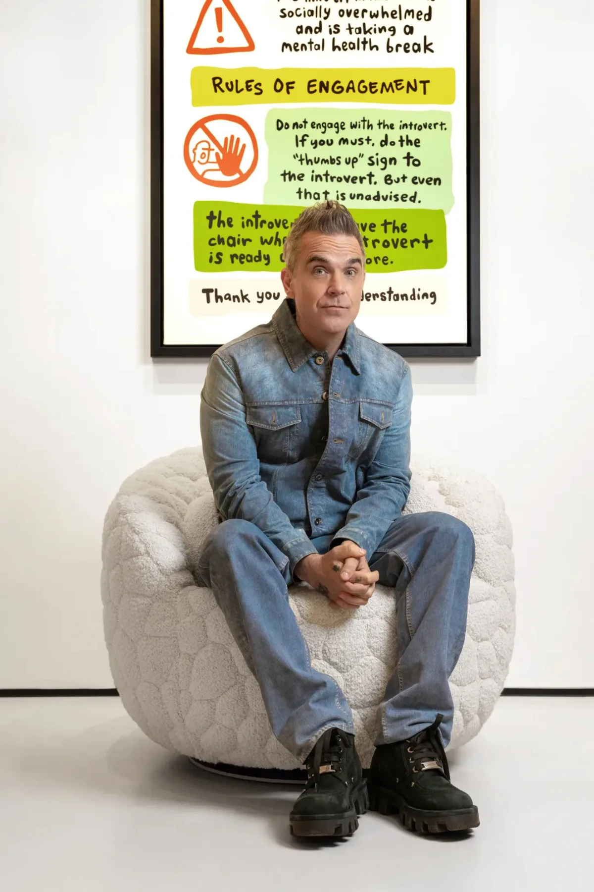 Robbie Williams sat on the Introvert Armchair he designed with Moooi