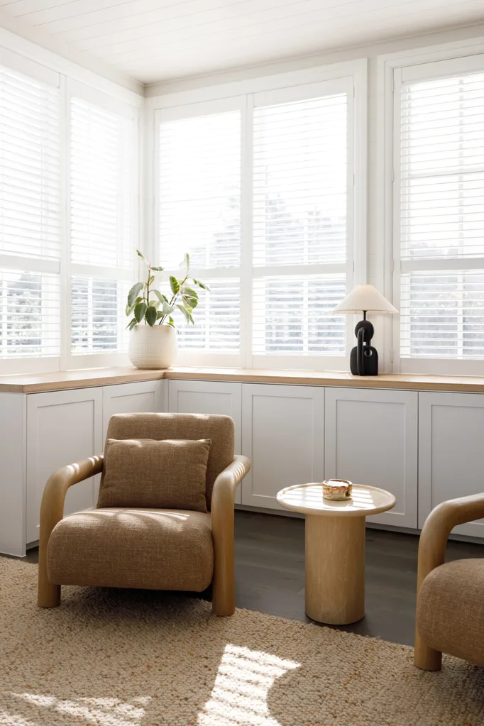 Light sitting room with two chairs and a side table