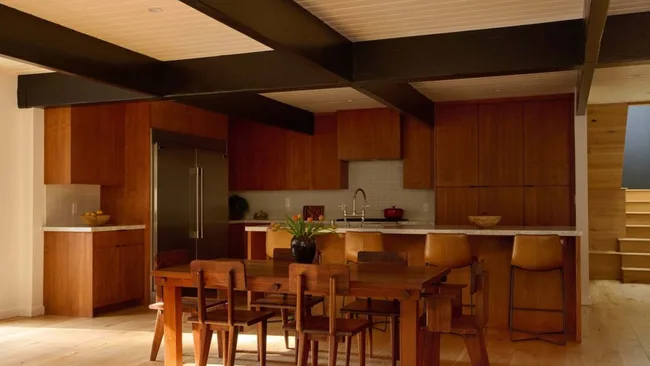 A timber kitchen with timber fining table and chairs