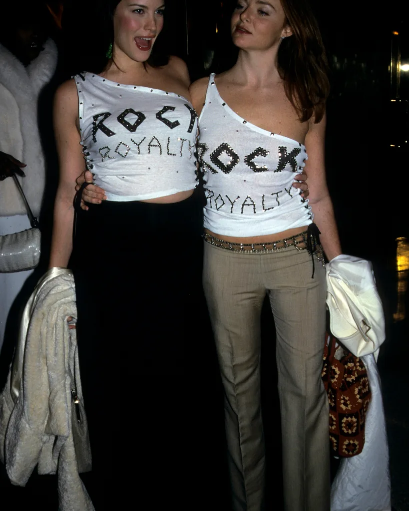 two women wearing shirts that say 'ROCK Royalty' and jeans posing