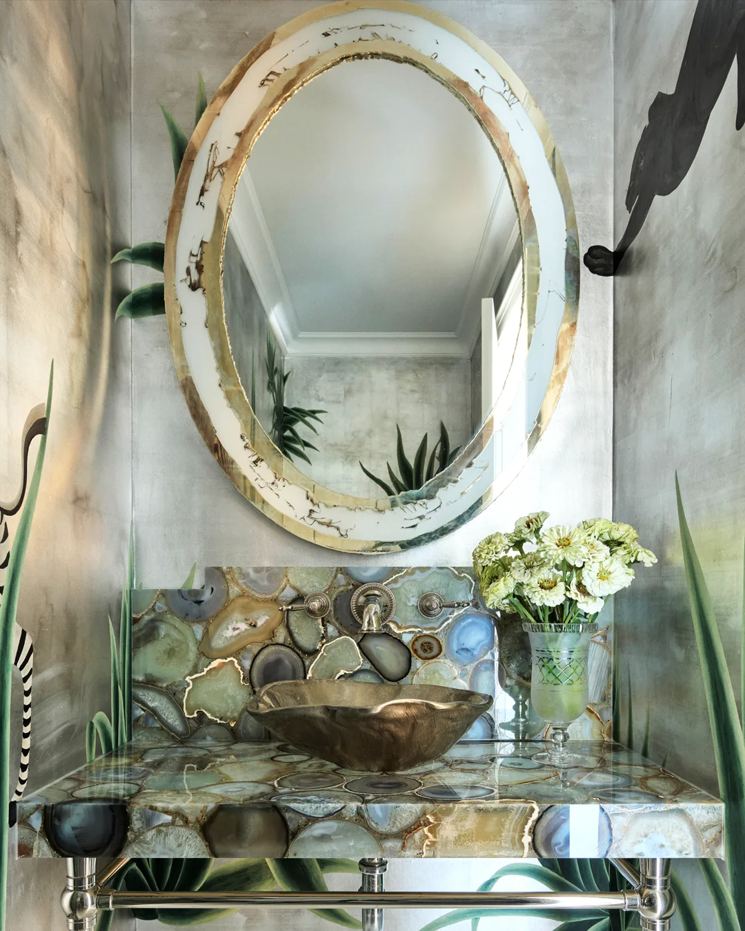 A oval, marble and gold mirror, metallic wallpaper, marble, turquoise basin and gold, abstract sink.