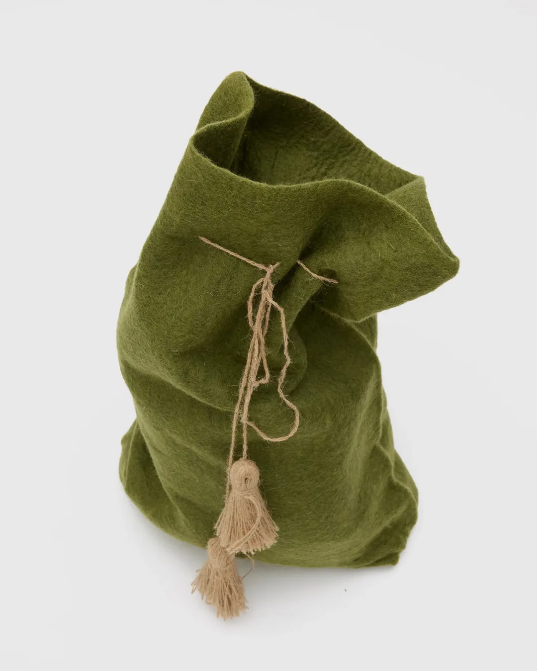 A green wool Christmas Santa sack with tan ribbon with tassels. 