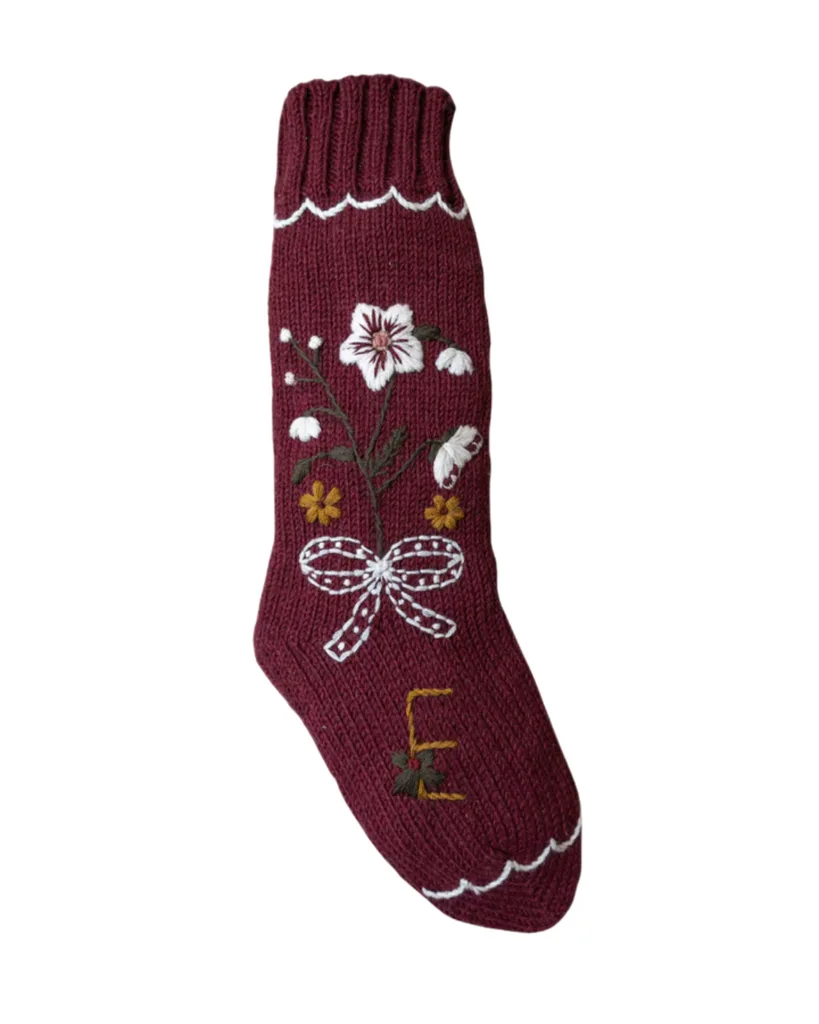 A wool embroidered Christmas stocking with flowers and the letter E