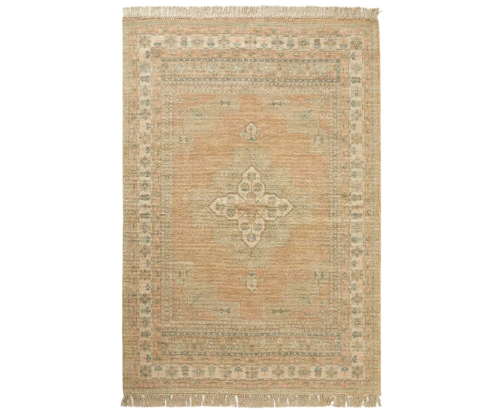 A burnt orange Persian rug with fringe