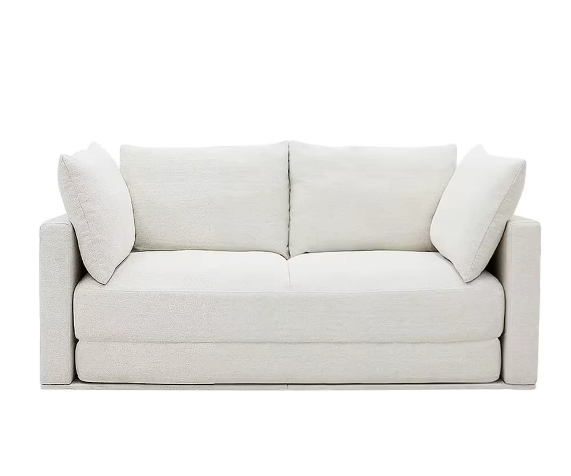 a white two seater couch with pillows placed on either end from
