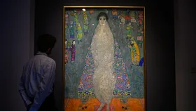An art handler stands in front of Bildnis Elisabeth Lederer (Portrait of Elisabeth Lederer), by Gustav Klimt, during a press preview at Sotheby's before the auction making it one of the most expensive paintings on November 07, 2025 in New York City.