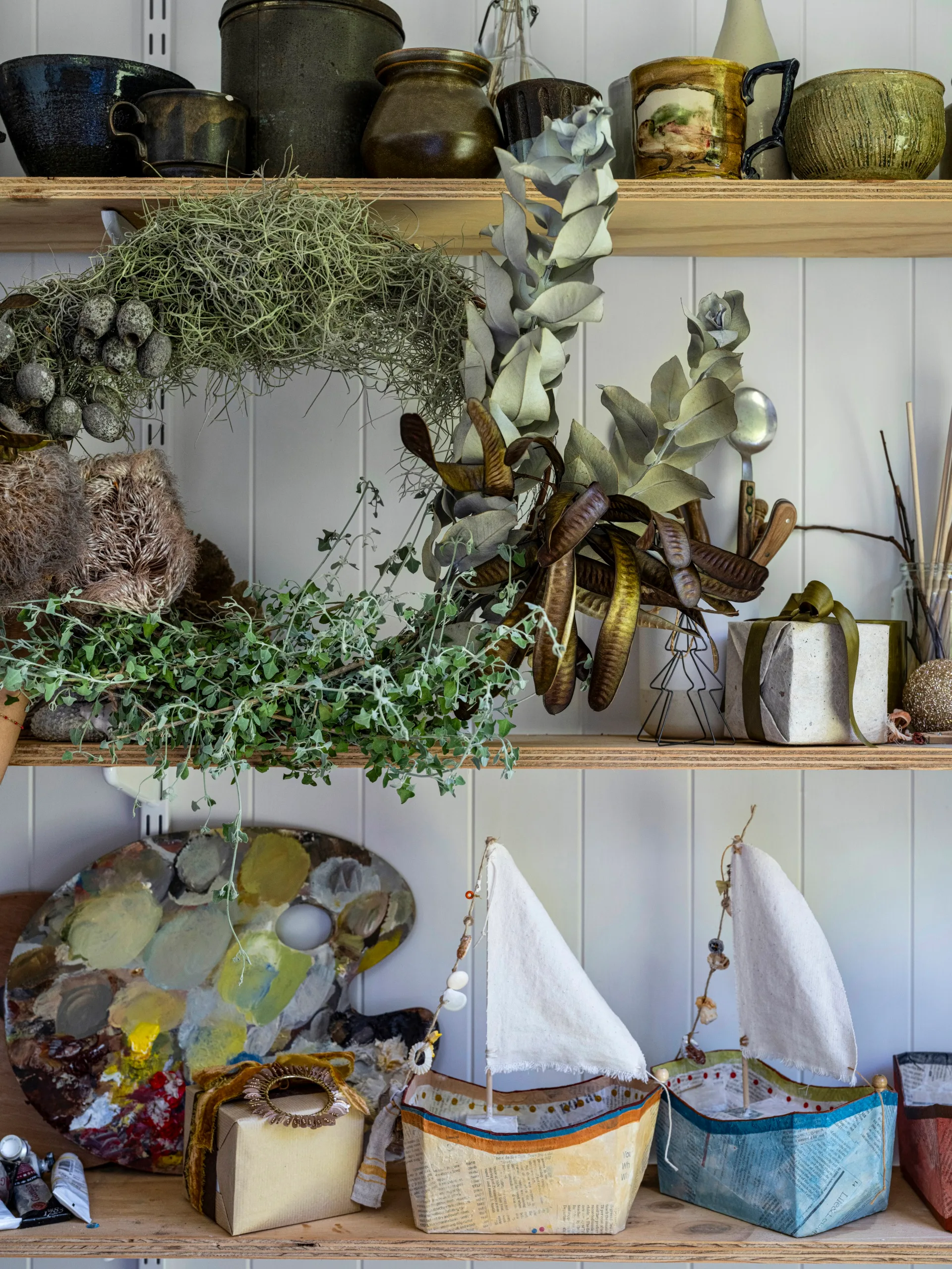 a native wreath and papier-mâché sailing ships