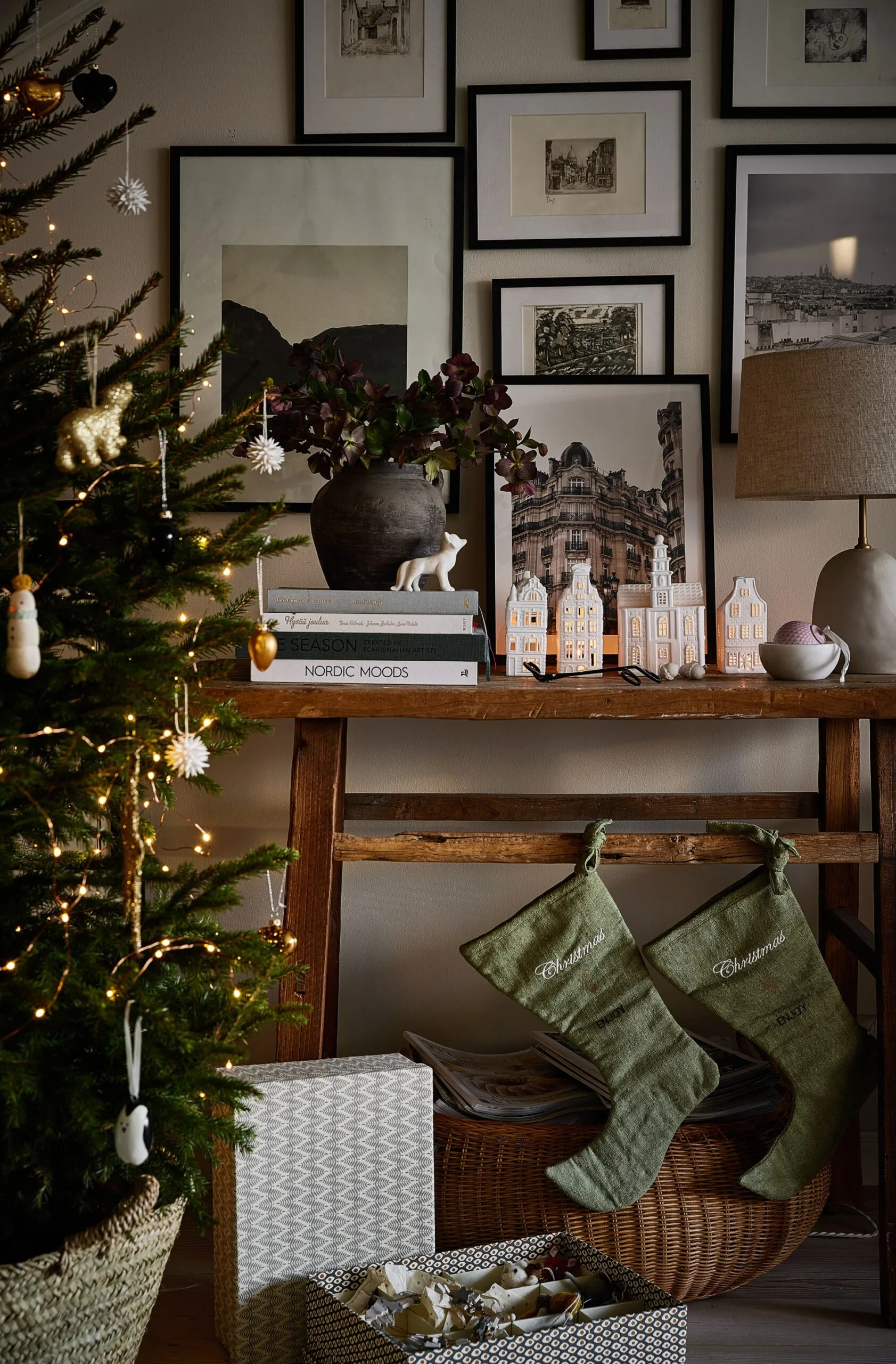 A festive scene with a gallery wall and Christmas tree