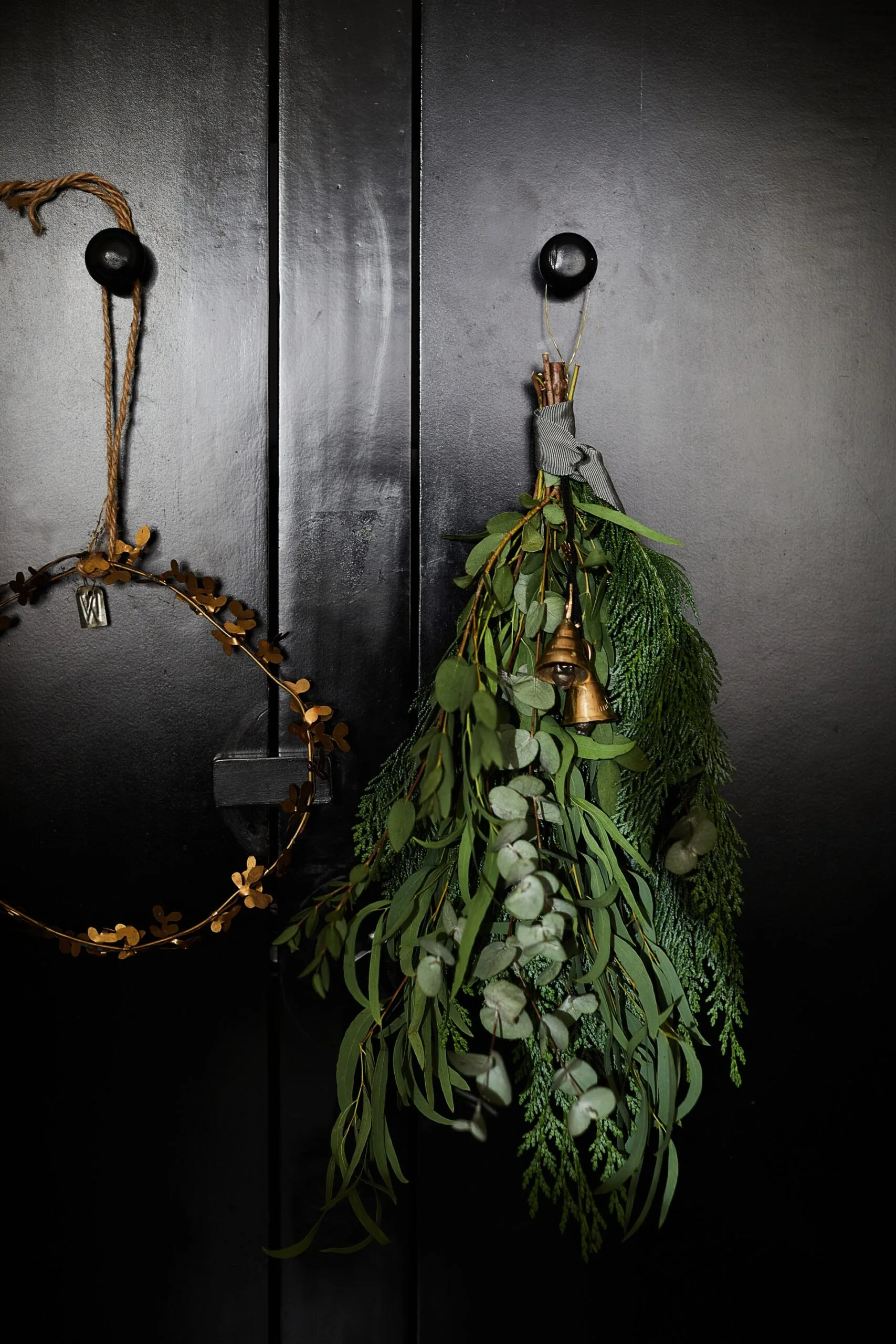 Handmade Christmas wreaths hanging on a black door