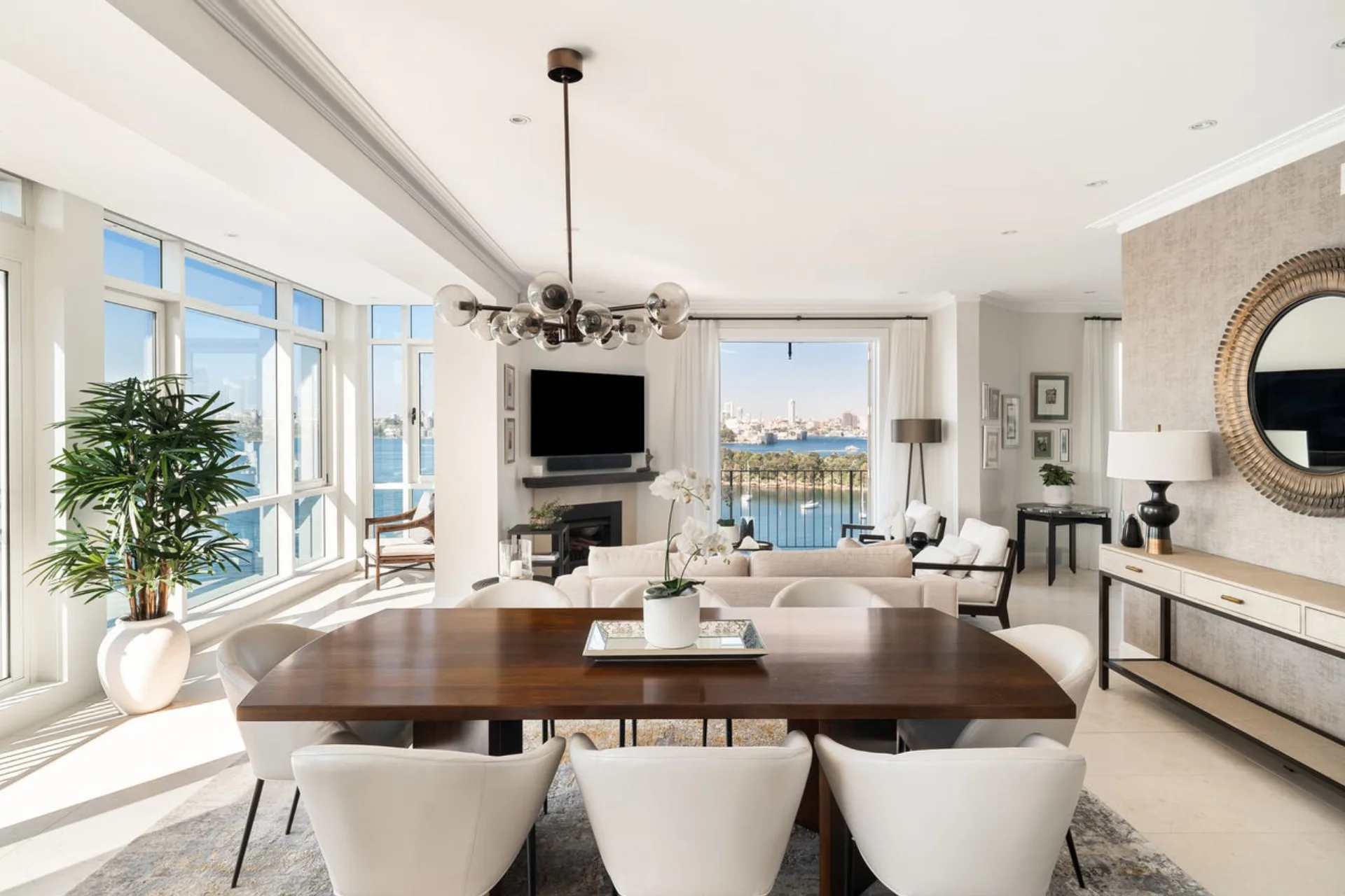 A white contemporary living and dining area of a Mosman penthouse