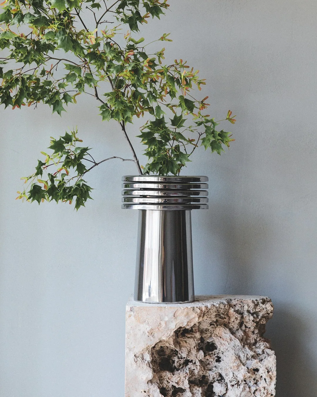 Louise Roe Fountain vases are hand-welded from polished, stainless steel, displaying a glossy finish that charmingly captures and reflects natural light. 