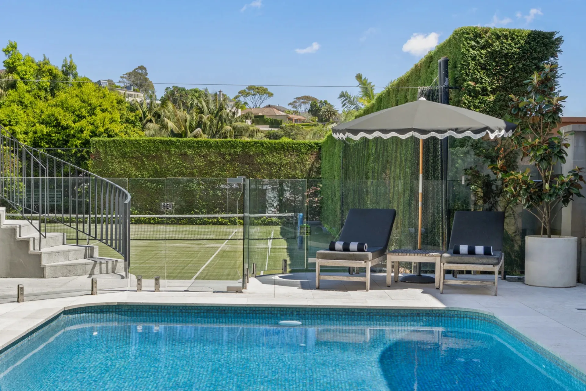 A swimming pool beside a tennis court in Vaucluse