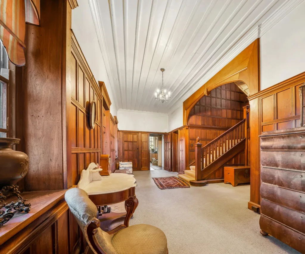 A grand entryway with timber panelling inside Wynstay Estate