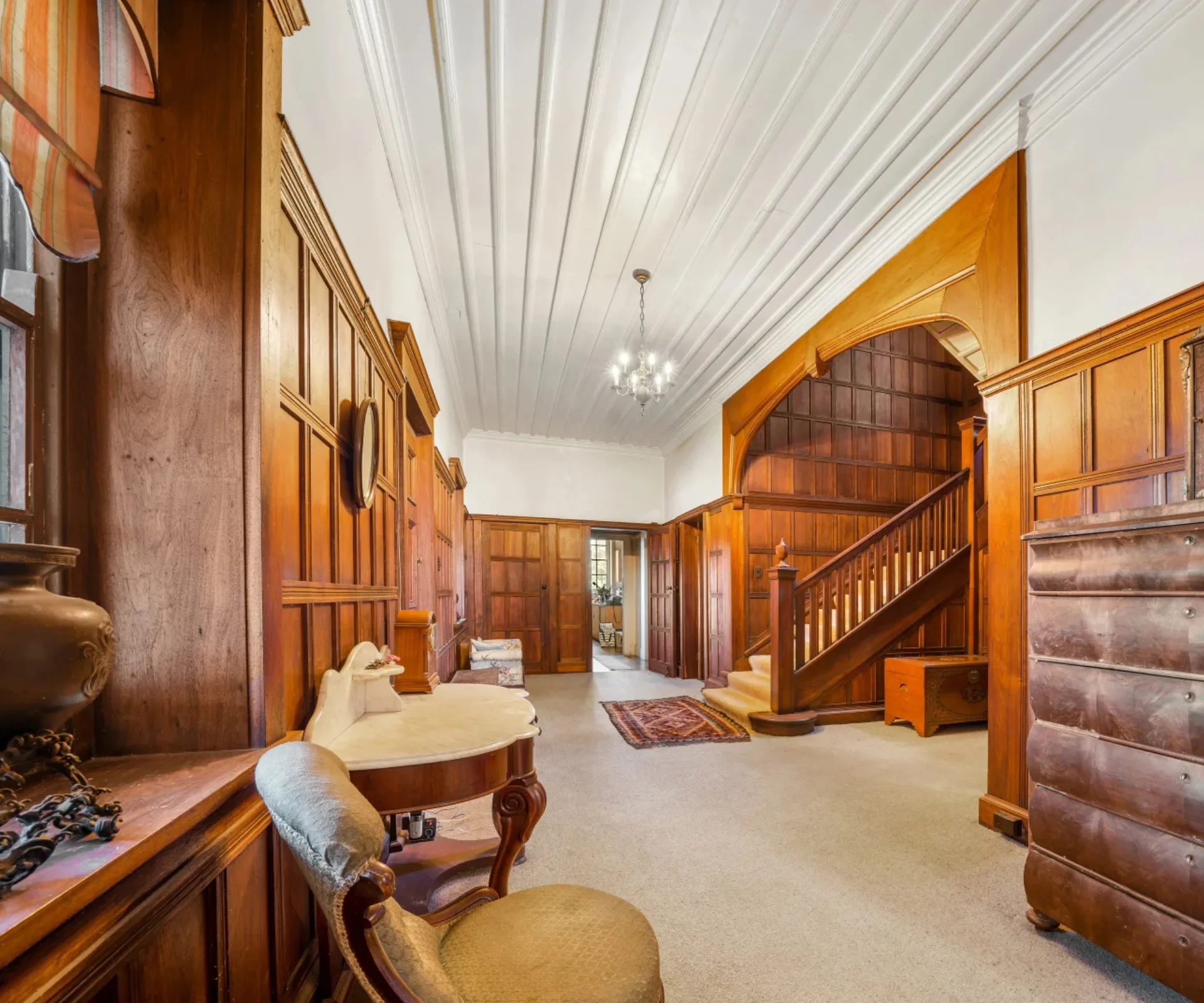 A grand entryway with timber panelling inside Wynstay Estate
