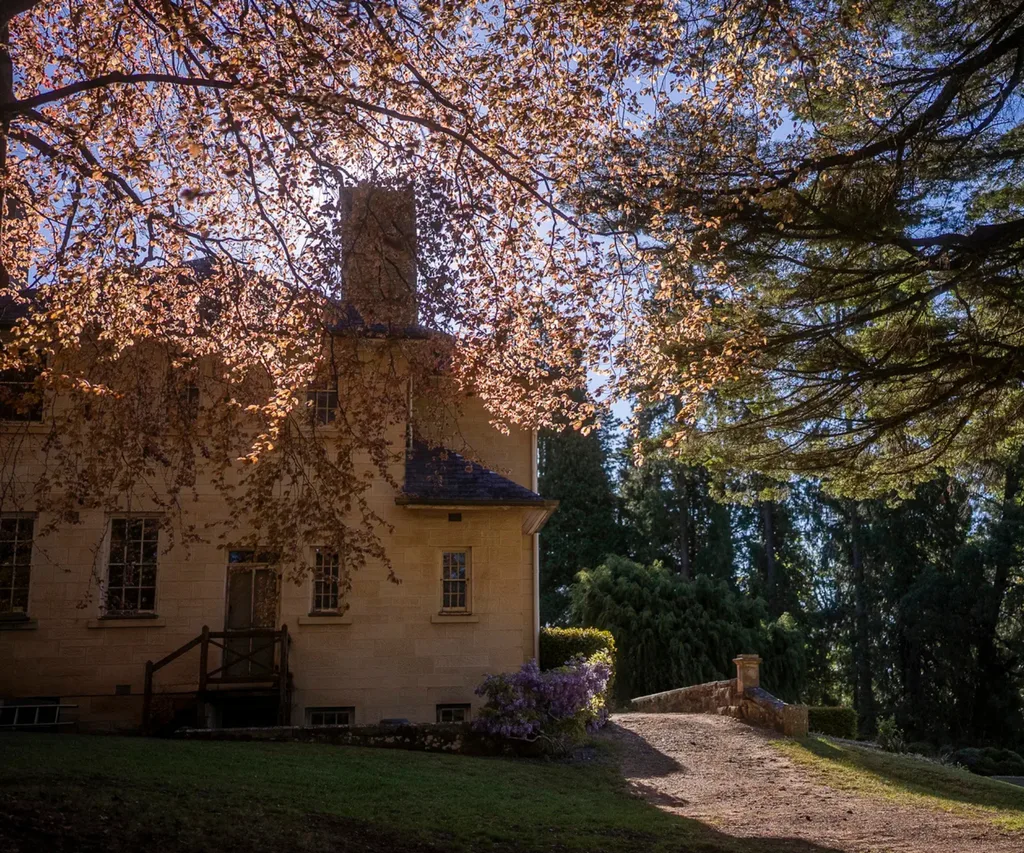 The Georgian stone facade of Wynstay Estate surrounded by trees