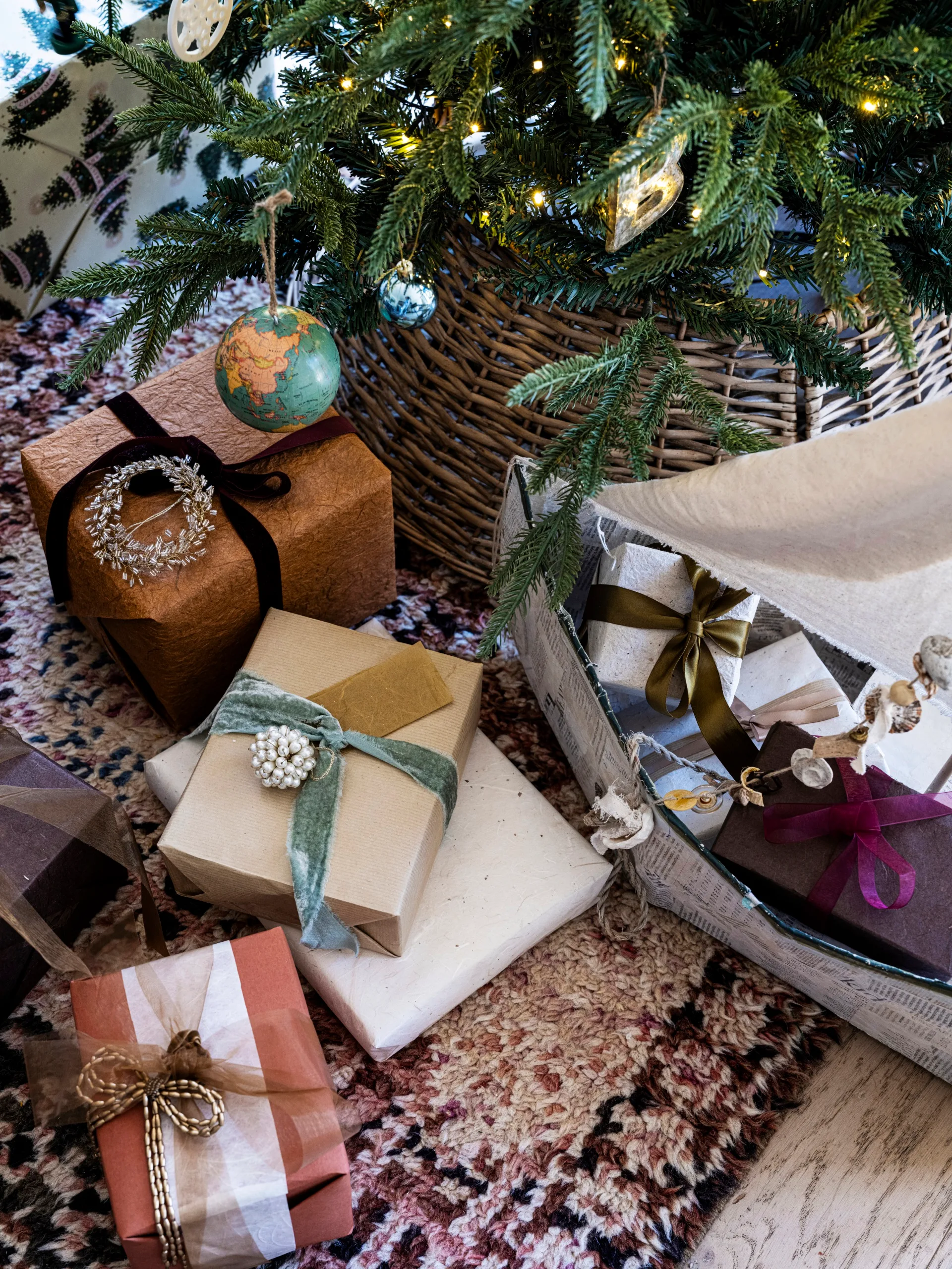 An assortment of Christmas gifts under a tree