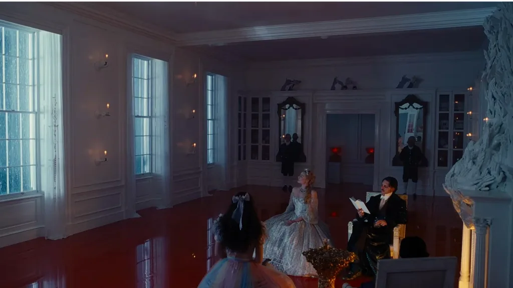 A still from 'Wuthering Heights' depicting a grand sitting room with red floors