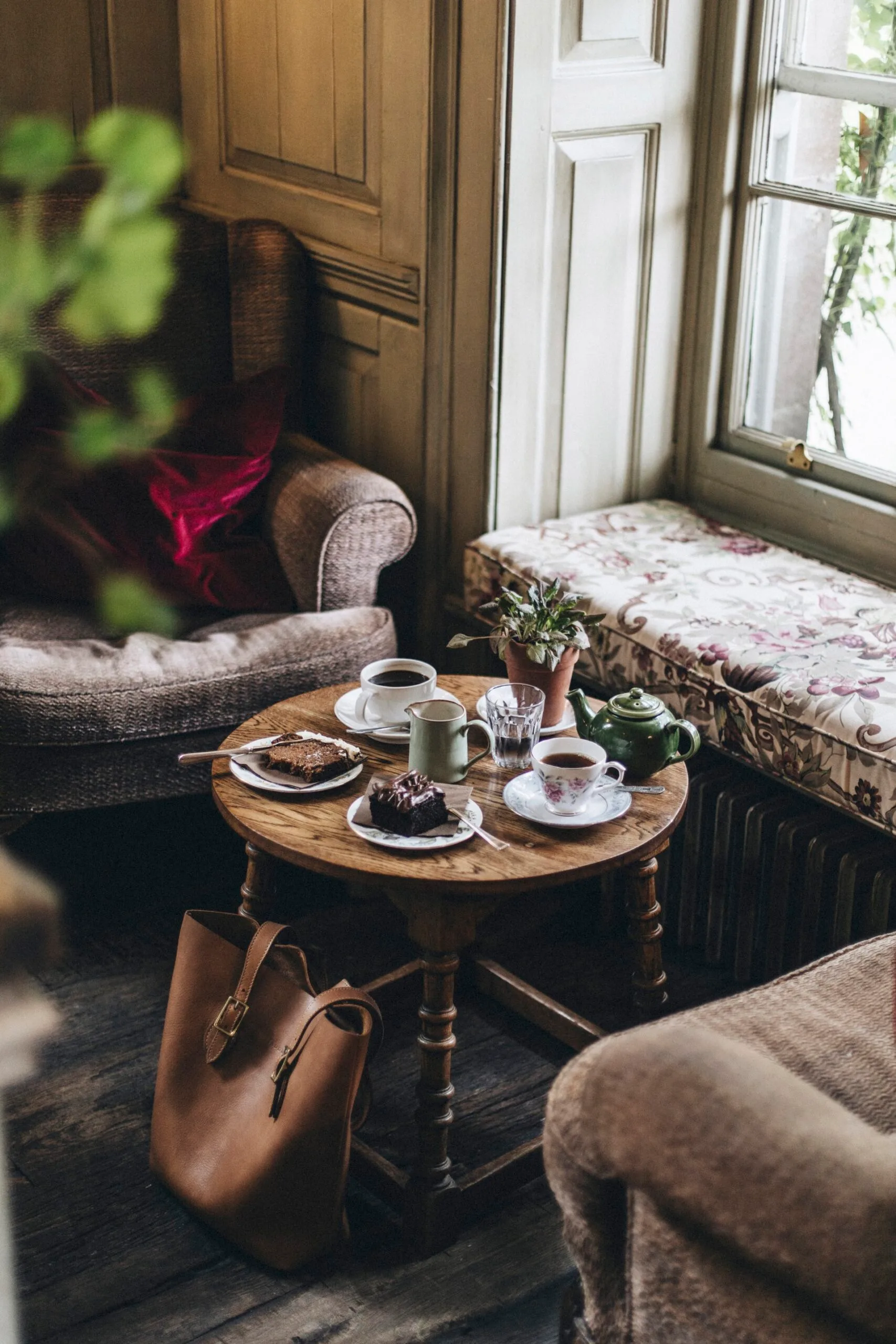 A window seat and a coffee table with coffee and cake
