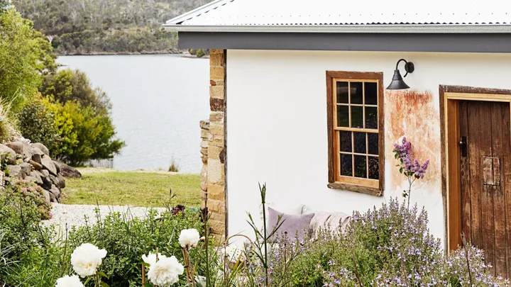 The white exterior of The Post House, a cottage stay in Carlton, Tasmania