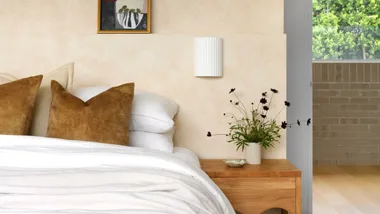 a neutral toned bedroom with white bedding.