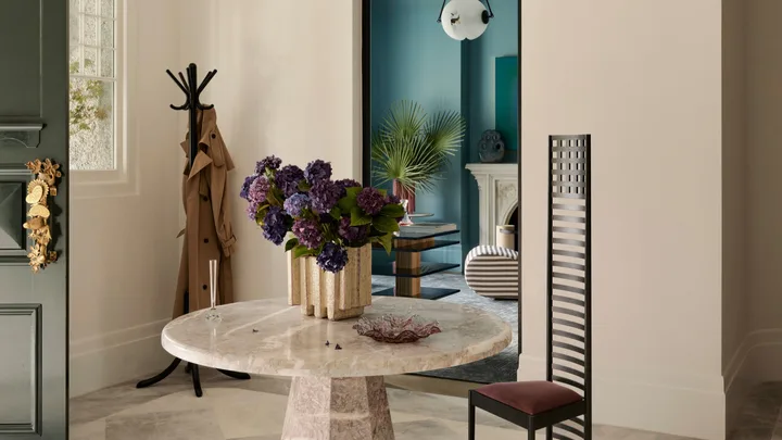 An Art Deco entry with marble table and statement chair