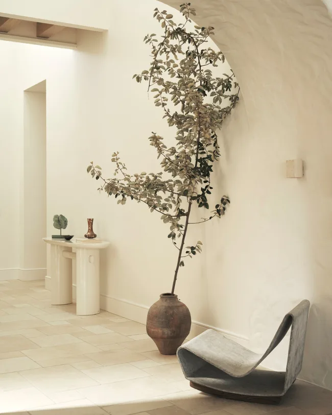 A white hallway with metal chair