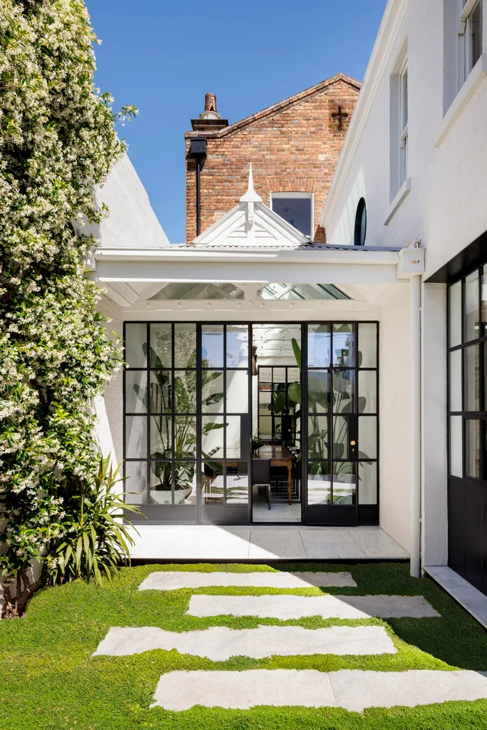 Steel framed windows into backyard
