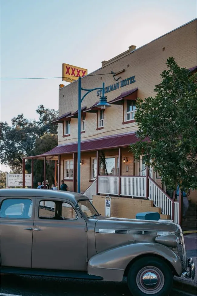 A vintage car parked outside the Stockman Hotel