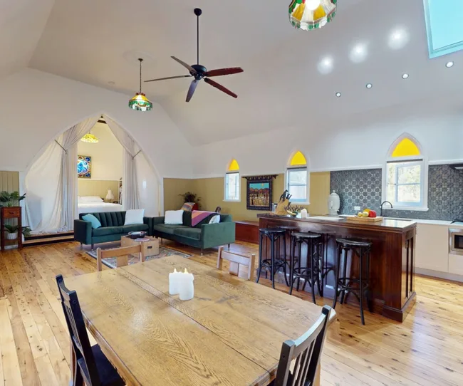converted Church for sale in Dubbo with renovated open plan interior and bedroom curtained off from main room.