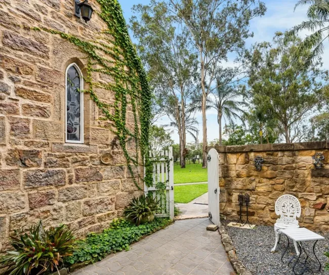 A courtyard next to the stone facade of a converted church in Greendale