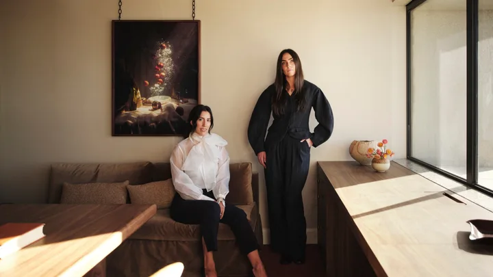 jillian Dinkel and assistant Romilly Pratt posing in an office