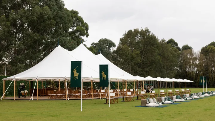 A marquee with Ralph Lauren flags on grass at Ralph Lauren Polo Cup