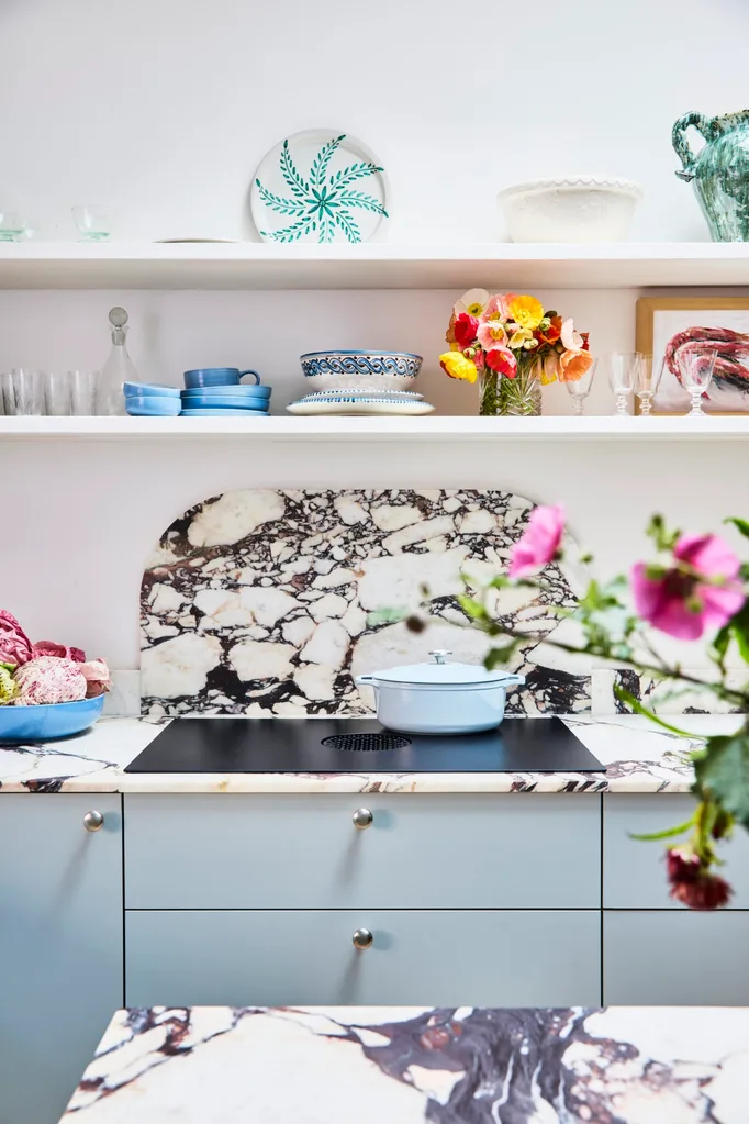 Danielle Alvarez home kitchen blue cabinetry with induction cooktop and calacatta viola marble splashback