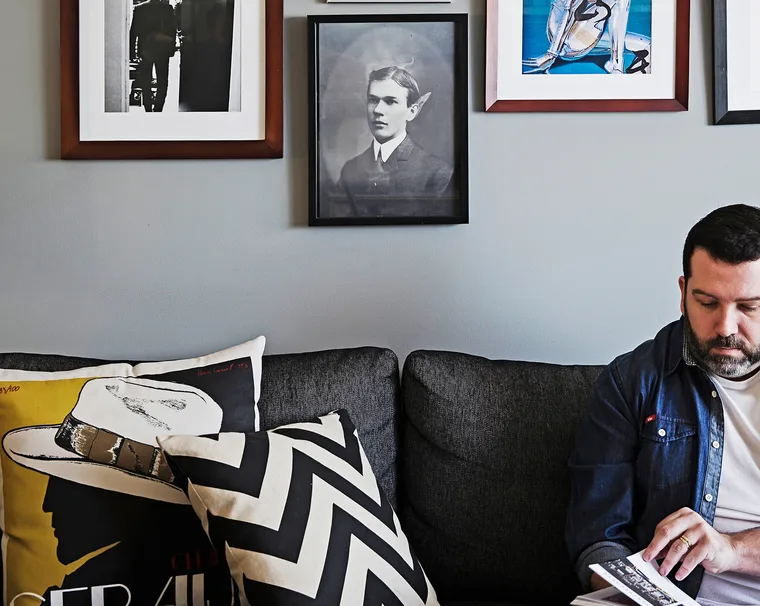 Homeowner Jet reads on the black couch