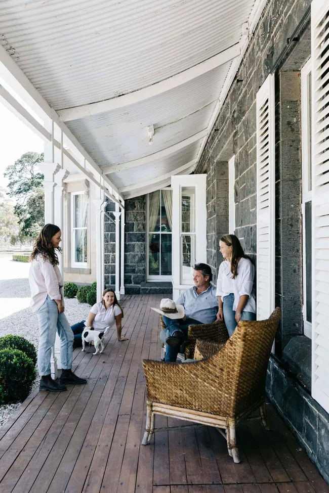 A family outside their bluestone homestead