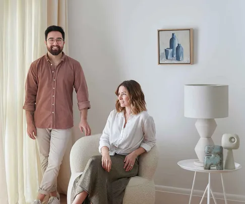 Jono Fleming standing next to Kerri-Ann Jones who is seated