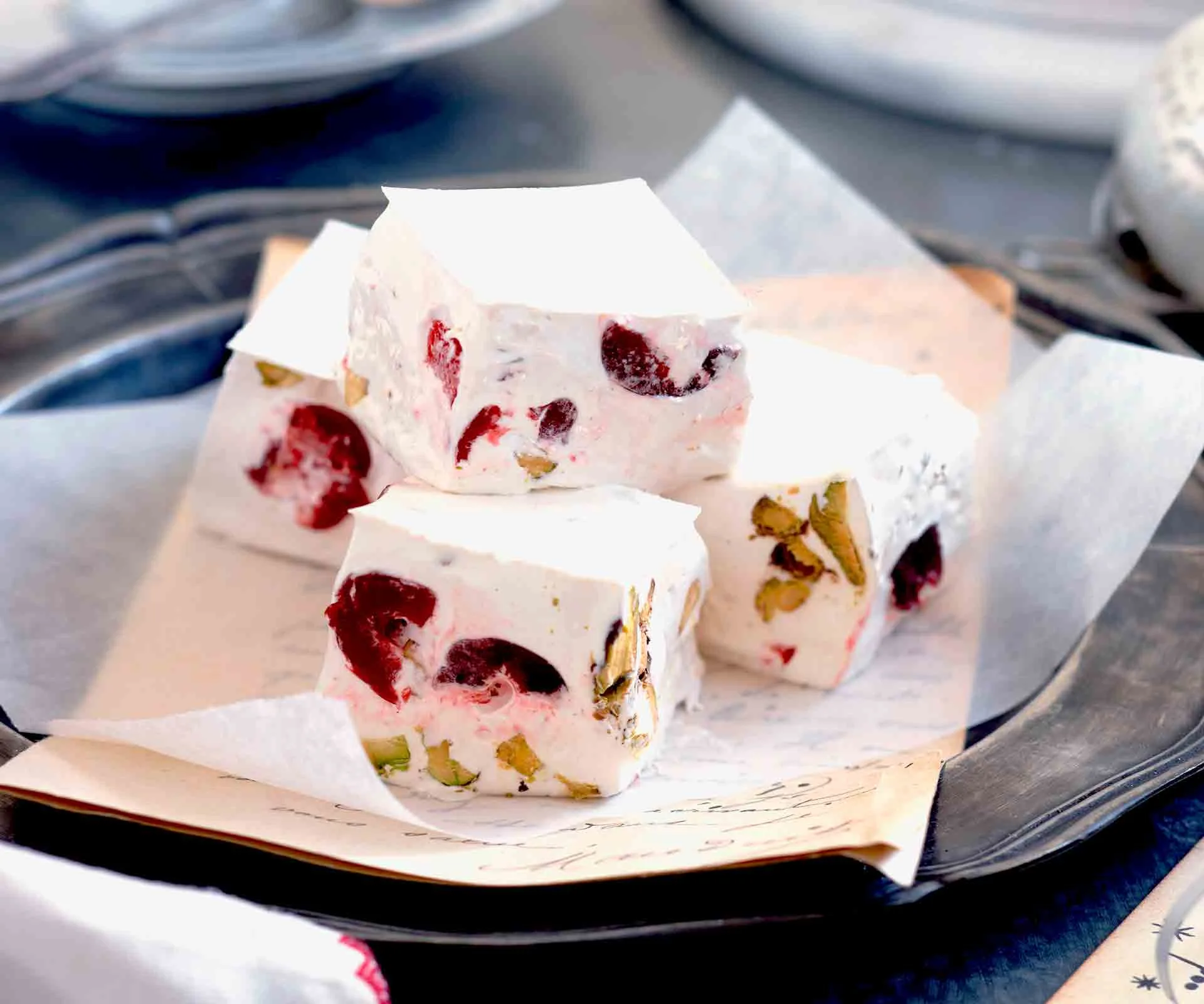 Nougat squares with cherries on a plate