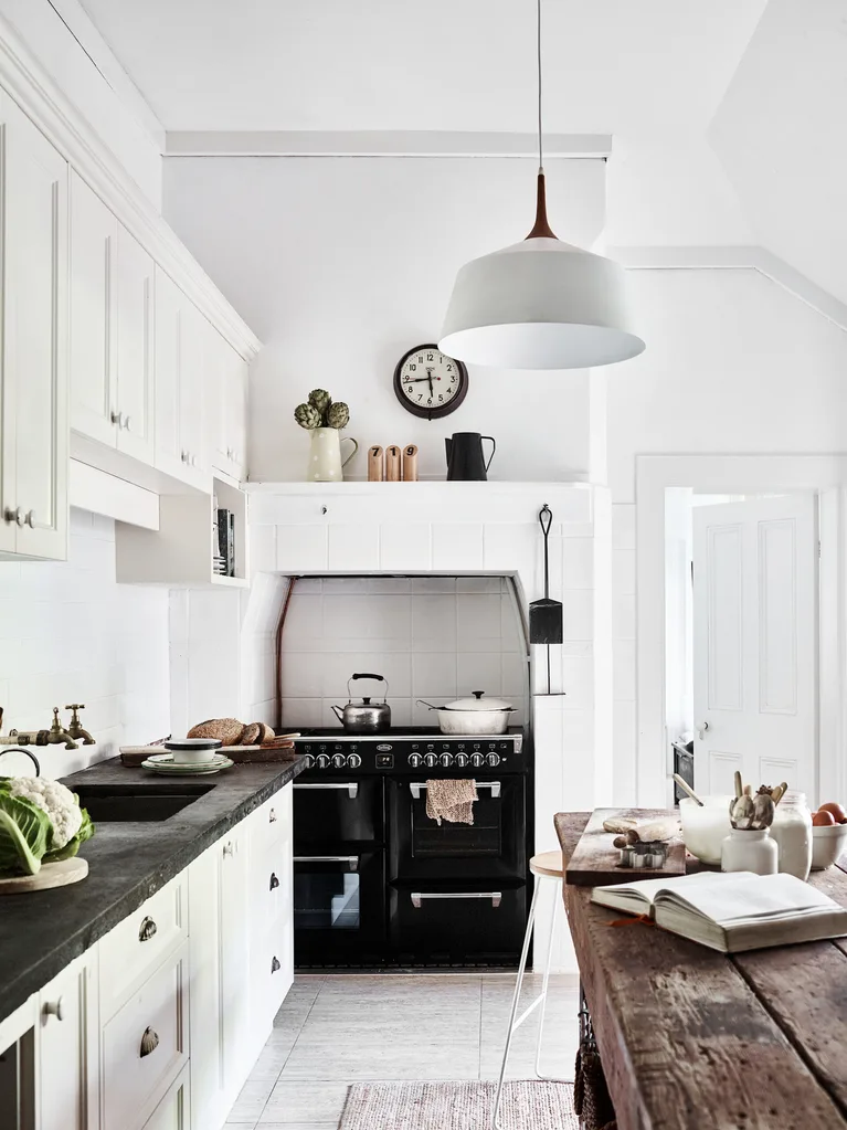 A white country kitchen with a timber workbench