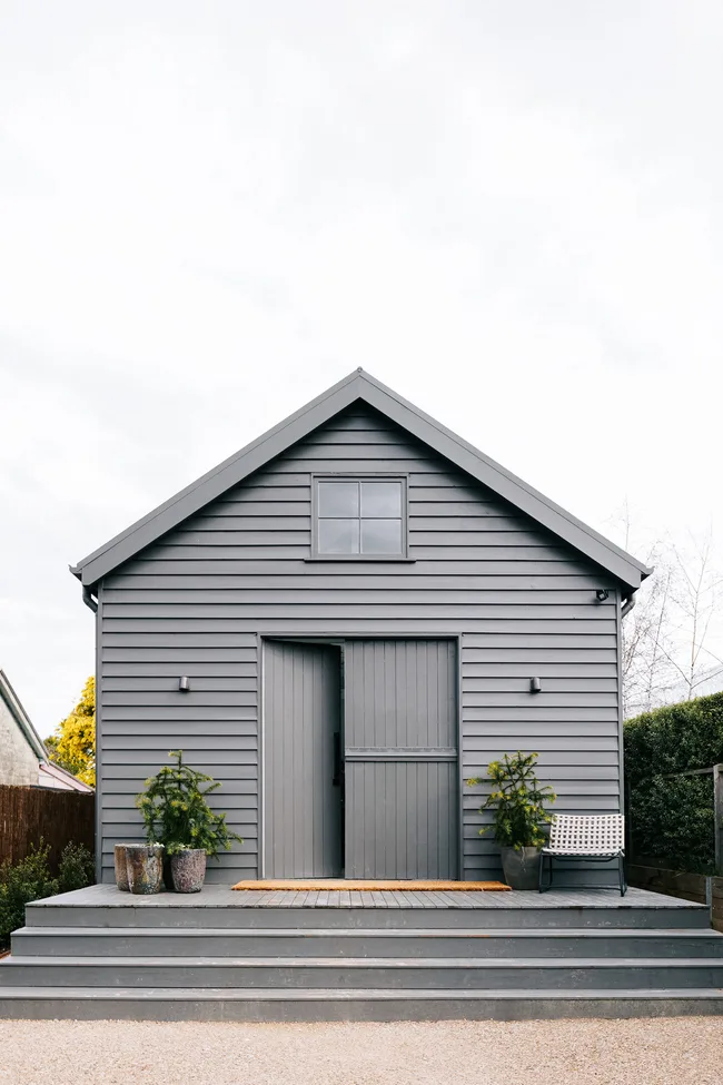 A barn style house painted grey