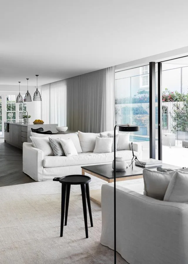 How to spring clean a large open-plan living room in a monochrome white and black colour palette.
