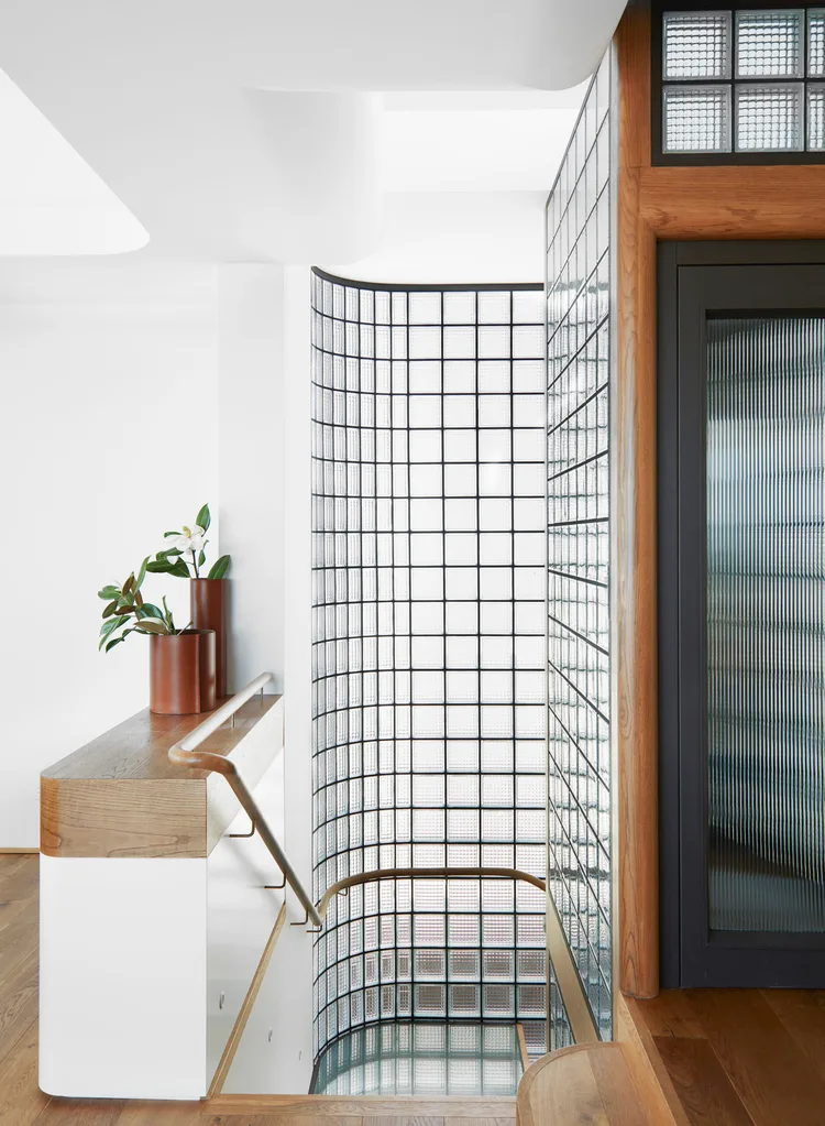 A staircase with a glass block feature