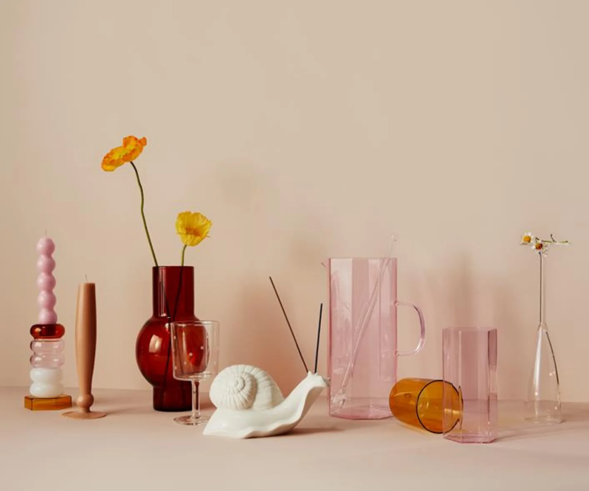 A collection of Maison Balzac glassware including a snail shaped incense holder