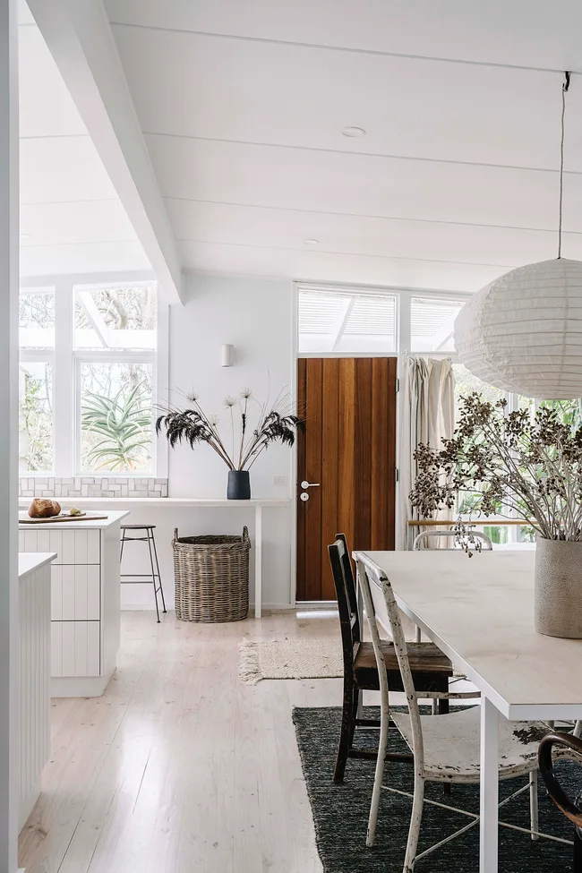 The white and bright interiors of a mid-century home with country-inspired styling