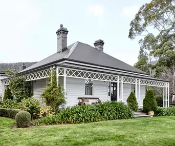 Exterior of heritage listed weatherboard farmhouse at Cloud River Farm in Tasmania