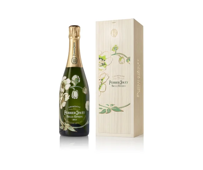 Champagne bottle of Perrier-Jou&euml;t Belle Epoque 2013 with floral design, next to matching elegant box.